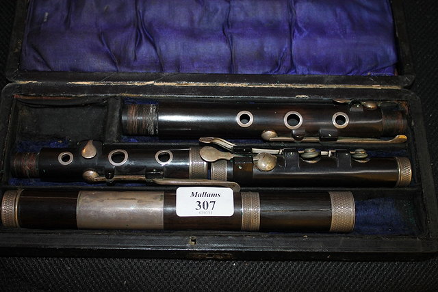 Appraisal: A ROSEWOOD AND SILVER METAL MOUNTED FLUTE in original lined