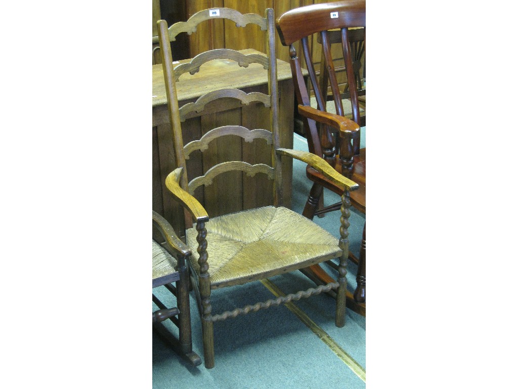 Appraisal: Oak ladder back rush seated armchair with barley twist supports