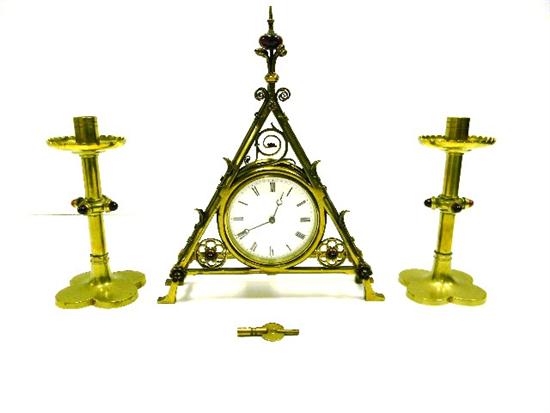 Appraisal: Bruce Talbert brass mantel clock and companion candlesticks faux red