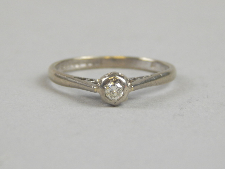 Appraisal: An ct white gold diamond solitaire ring with tiny diamonds