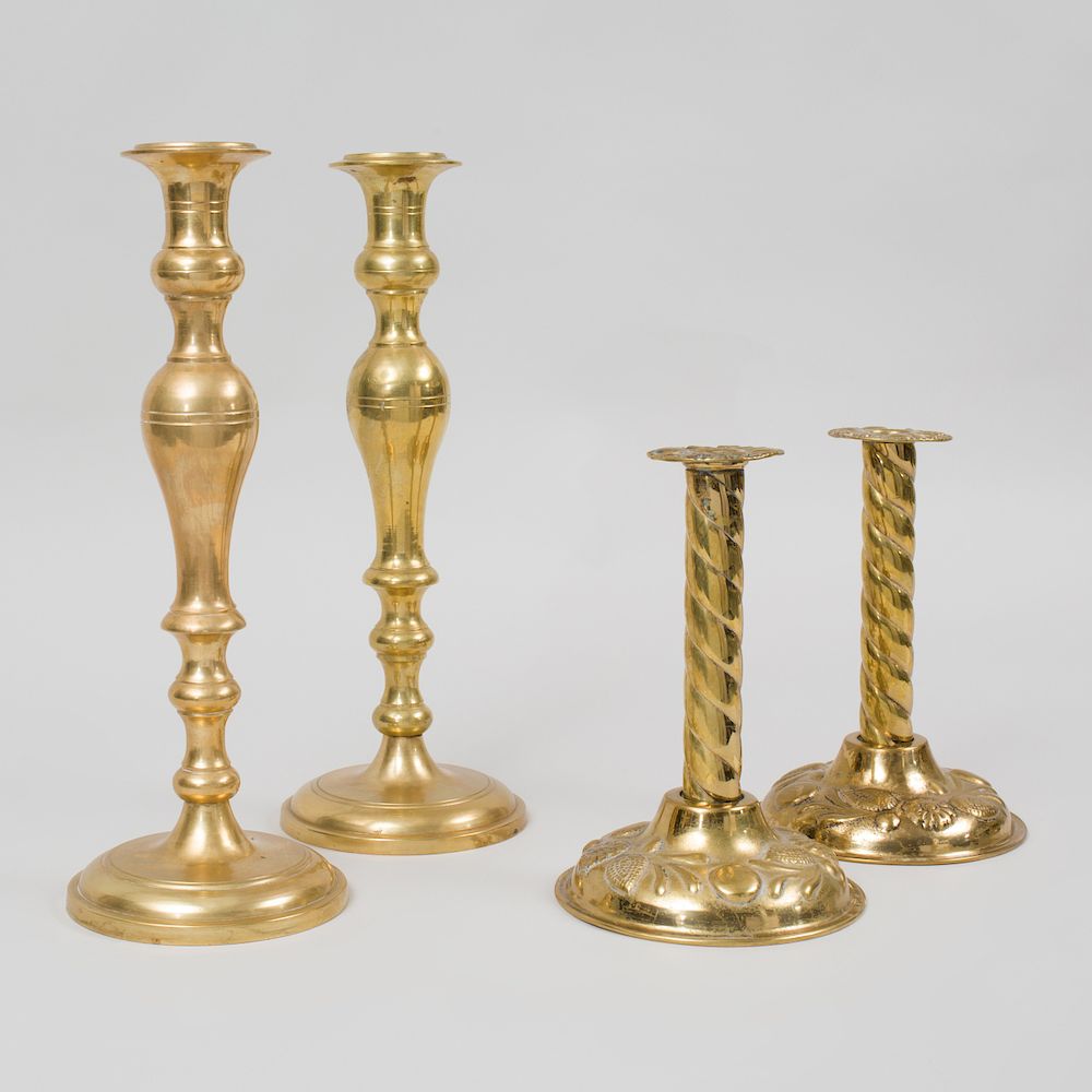 Appraisal: Two Pairs of Continental Brass Candlesticks The smaller repouss with