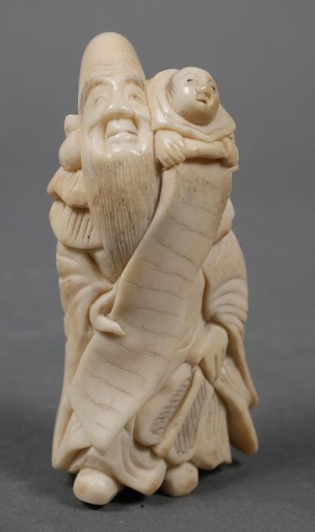 Appraisal: Old Japanese carved netsuke of old man with child on