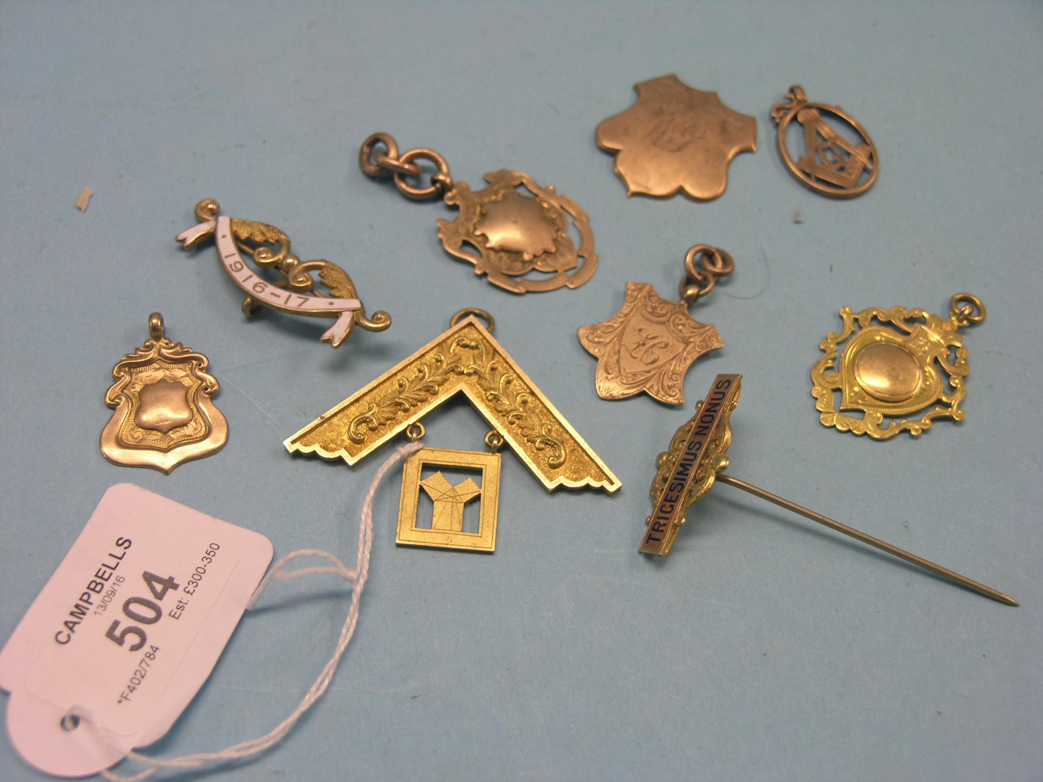 Appraisal: Nine various ct gold badges-pendants two with enamelled detail grams