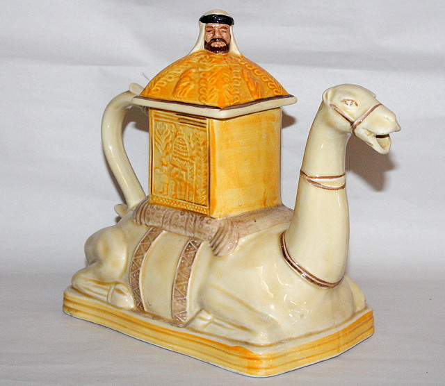 Appraisal: A TEAPOT in the form of a seated camel and