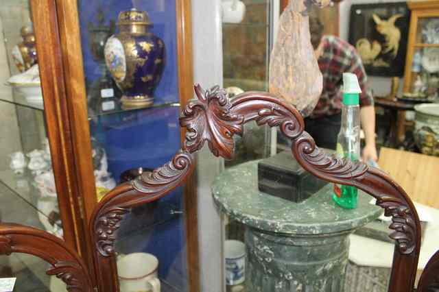 Appraisal: A MAHOGANY THREE FOLD SCREEN with glazed panels and scrolling