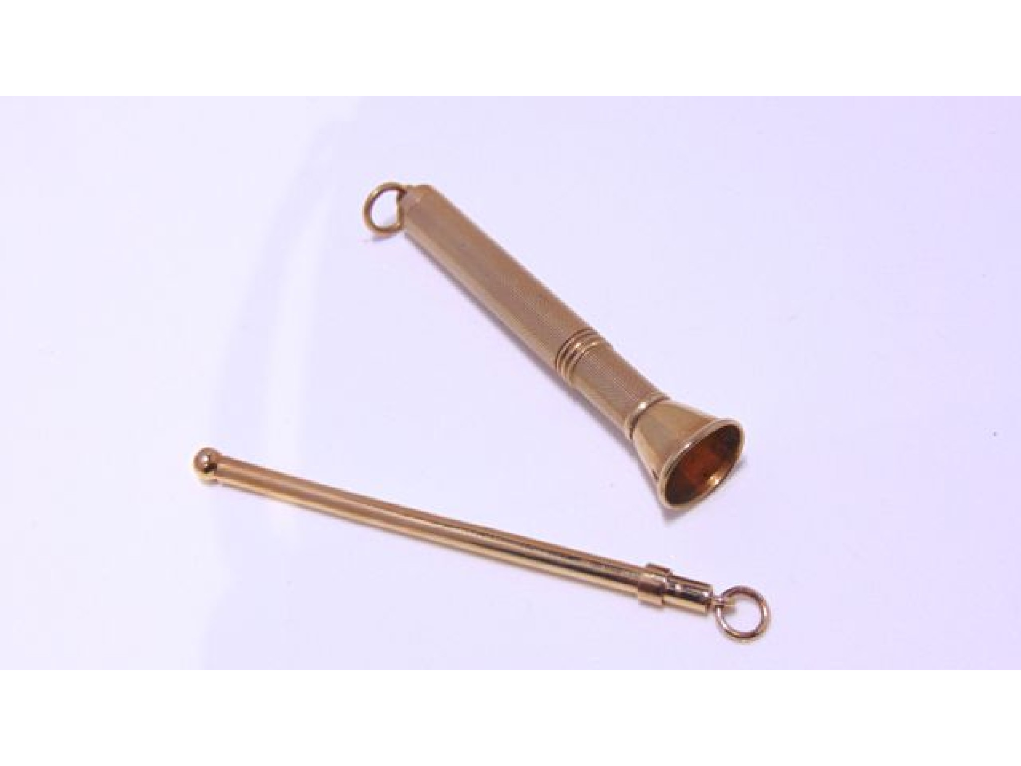 Appraisal: A ct gold cigar piercer with engine-turned decoration g and