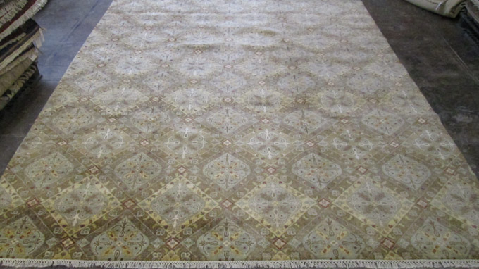 Appraisal: HAND KNOTTED ORIENTAL CARPET featuring an overall repeating panel design