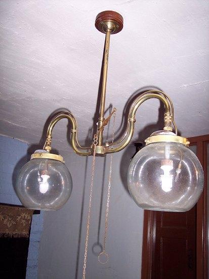 Appraisal: A brass ceiling light with twin glass shades