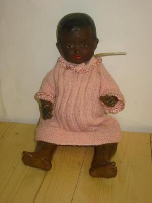 Appraisal: An Armand Marseille black bisque baby doll with moulded wig