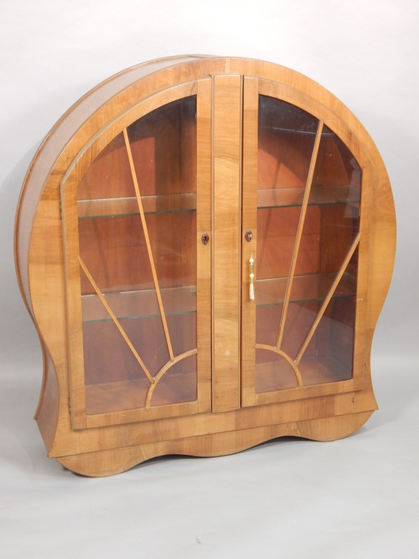 Appraisal: A walnut display cabinet of arched form Art Deco style