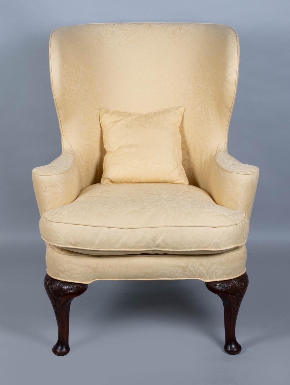 Appraisal: GEORGE III STYLE MAHOGANY WING ARMCHAIR the curved eared padded