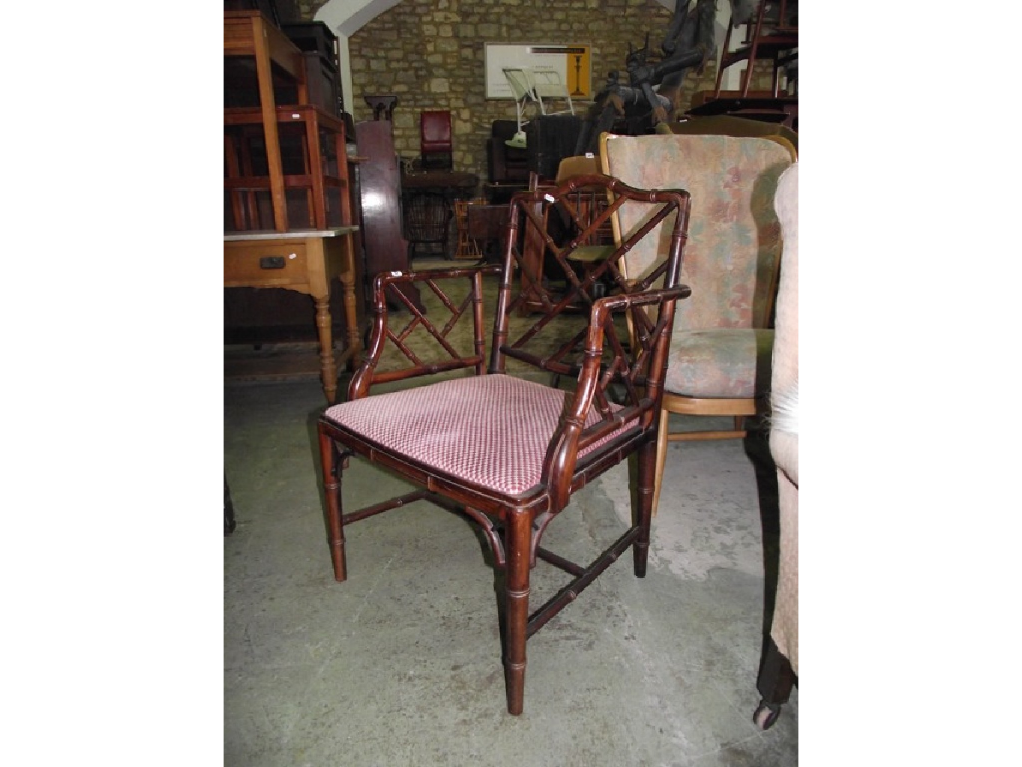 Appraisal: A stained beechwood simulated bamboo framed elbow chair with upholstered