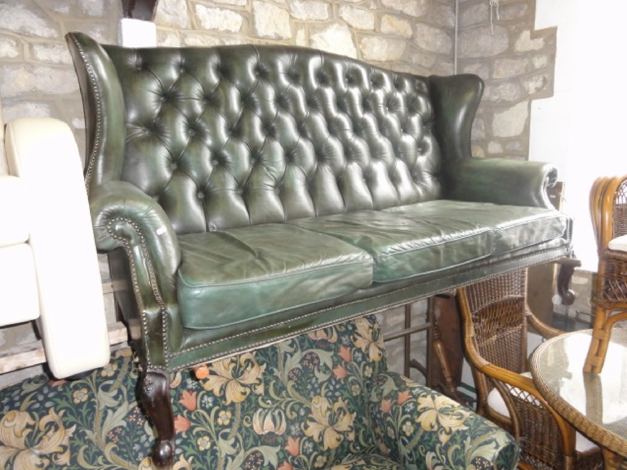 Appraisal: A Georgian style three seat sofa green leather upholstered rolled