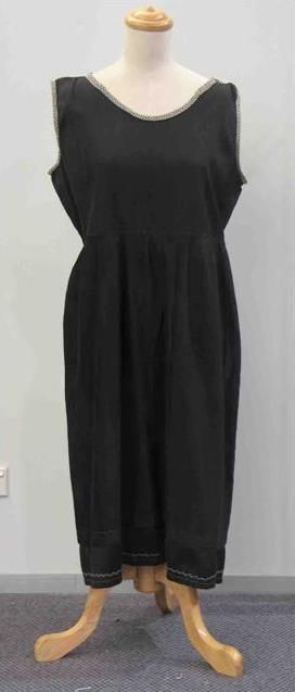 Appraisal: Dinner dress in black rayon with beige taped trim to