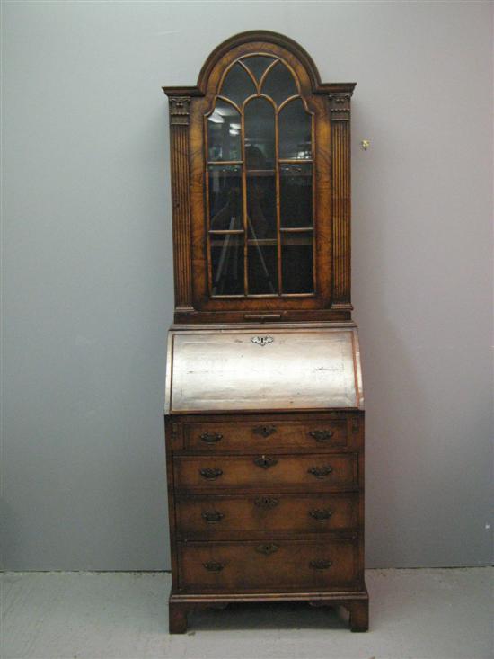 Appraisal: th century walnut bureau bookcase with domed glazed top above