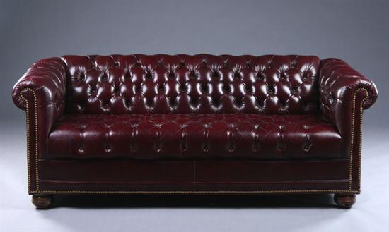 Appraisal: CHESTERFIELD STYLE SOFA late th century oxblood leather Tufted leather