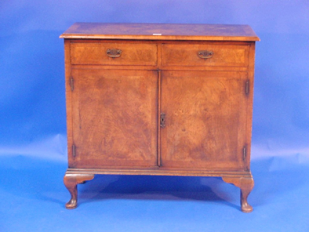 Appraisal: A walnut side cabinet with moulded top and two drawers