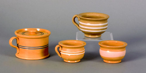 Appraisal: Three small yelloware cups th c together with a mustard