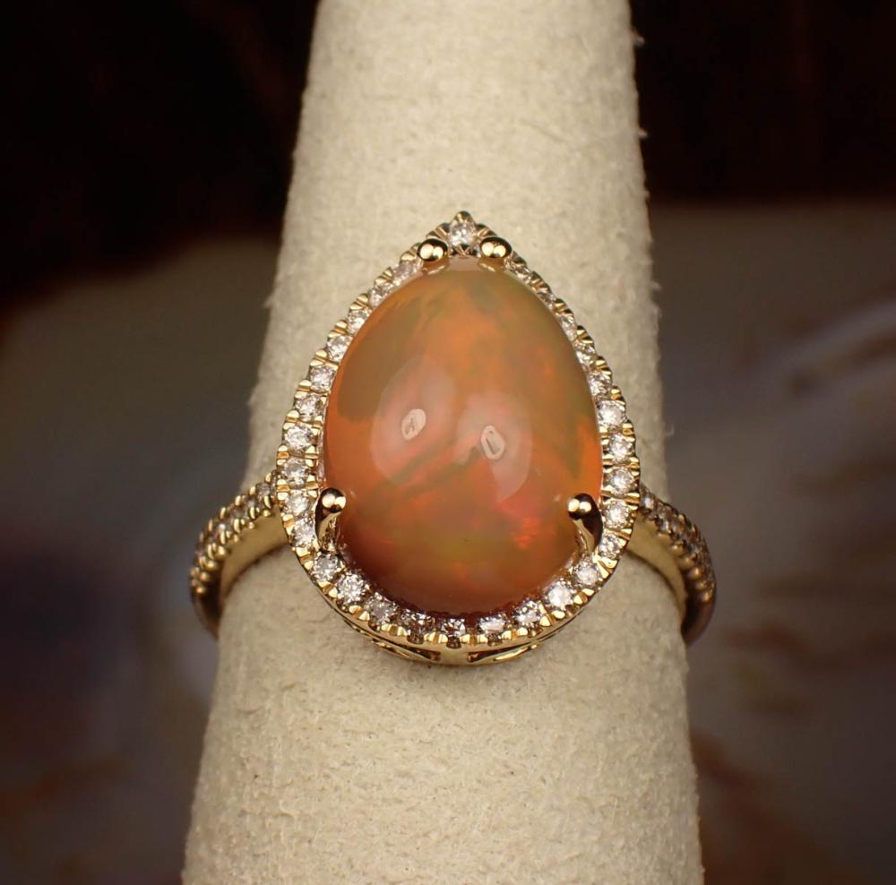 Appraisal: FIRE OPAL DIAMOND AND FOURTEEN KARAT GOLD RING The yellow