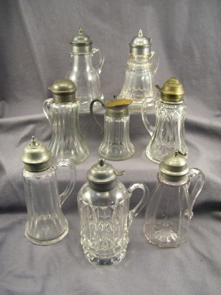 Appraisal: - Pattern Glass Lidded Syrup Bottles Measuring in height from