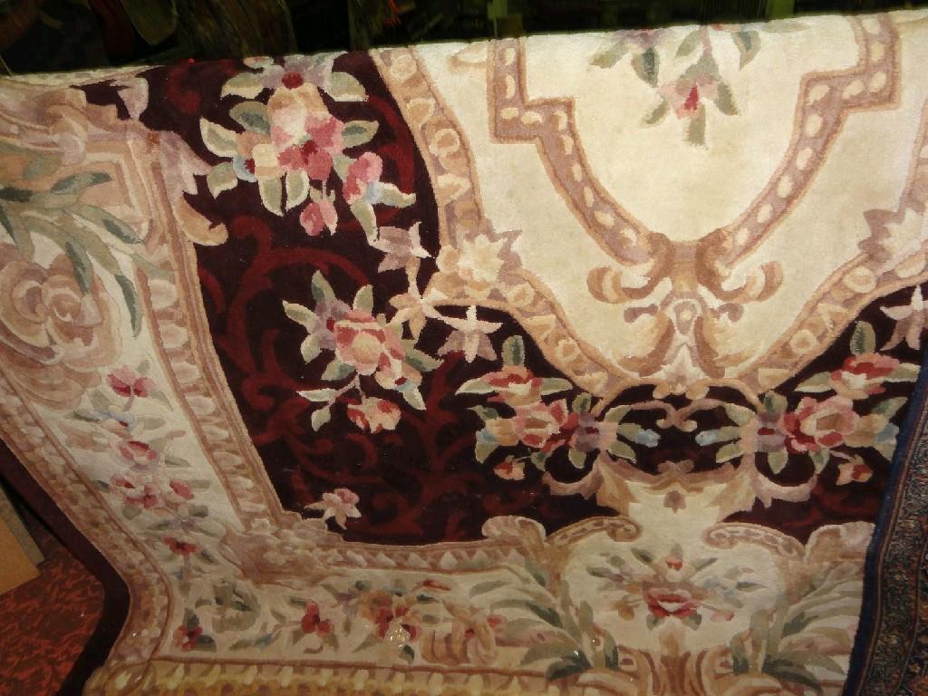 Appraisal: A large wool Aubusson style carpet with central floral pattern