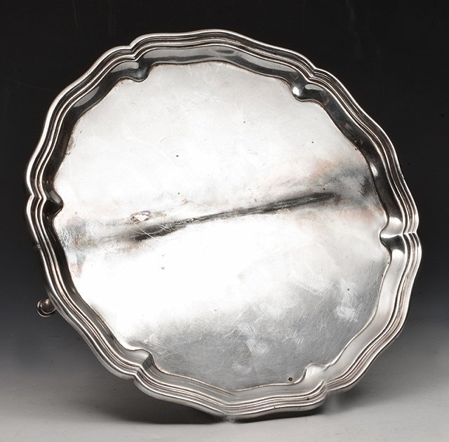 Appraisal: A SILVER WAITER with shaped sides and standing on three