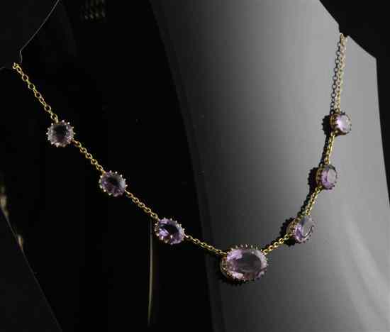 Appraisal: A gold mounted amethyst necklace hung with seven graduated stones