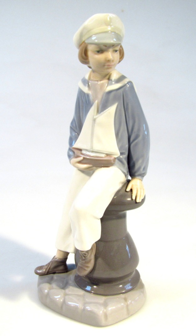 Appraisal: A thC Lladro figure no of a child holding yacht