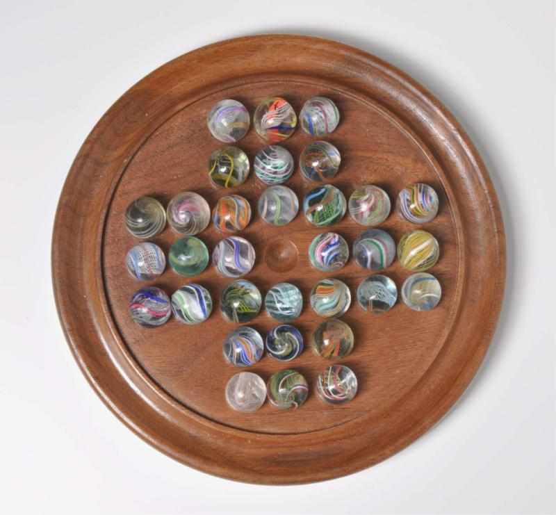 Appraisal: Solitaire Board with Swirl Marbles Description Includes latticino and divided