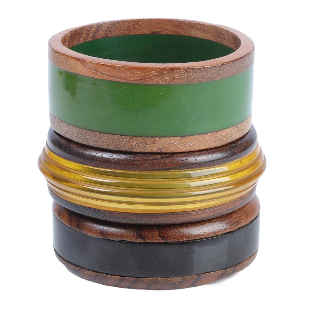 Appraisal: THREE WIDE BAKELITE AND WOOD LAMINATED BANGLE BRACELETS INNER DIAM