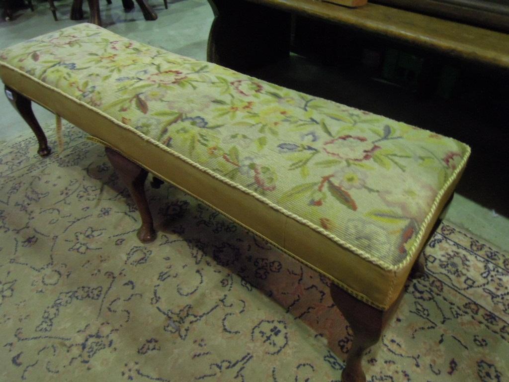 Appraisal: A long elongated rectangular stool with floral tapestry upholstered seat