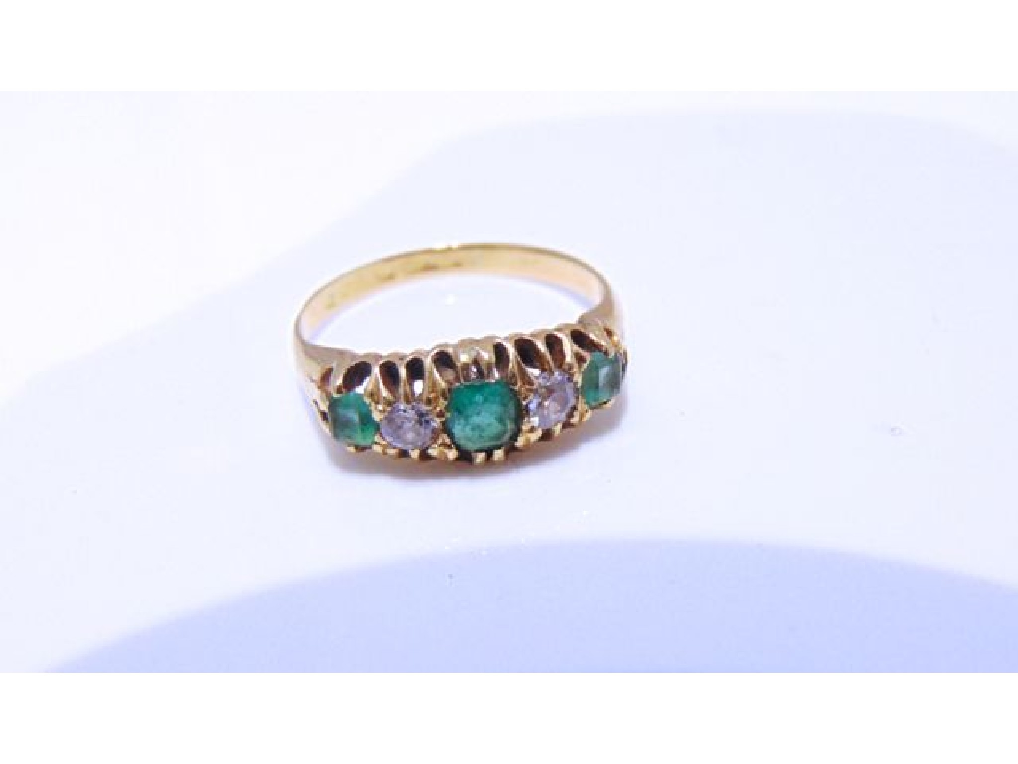 Appraisal: An Edwardian emerald and diamond ring the central emerald flanked