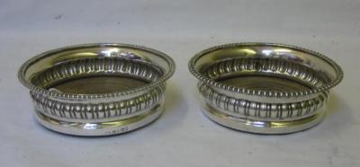 Appraisal: A PAIR OF GEORGIAN COASTERS of circular form with gadrooned