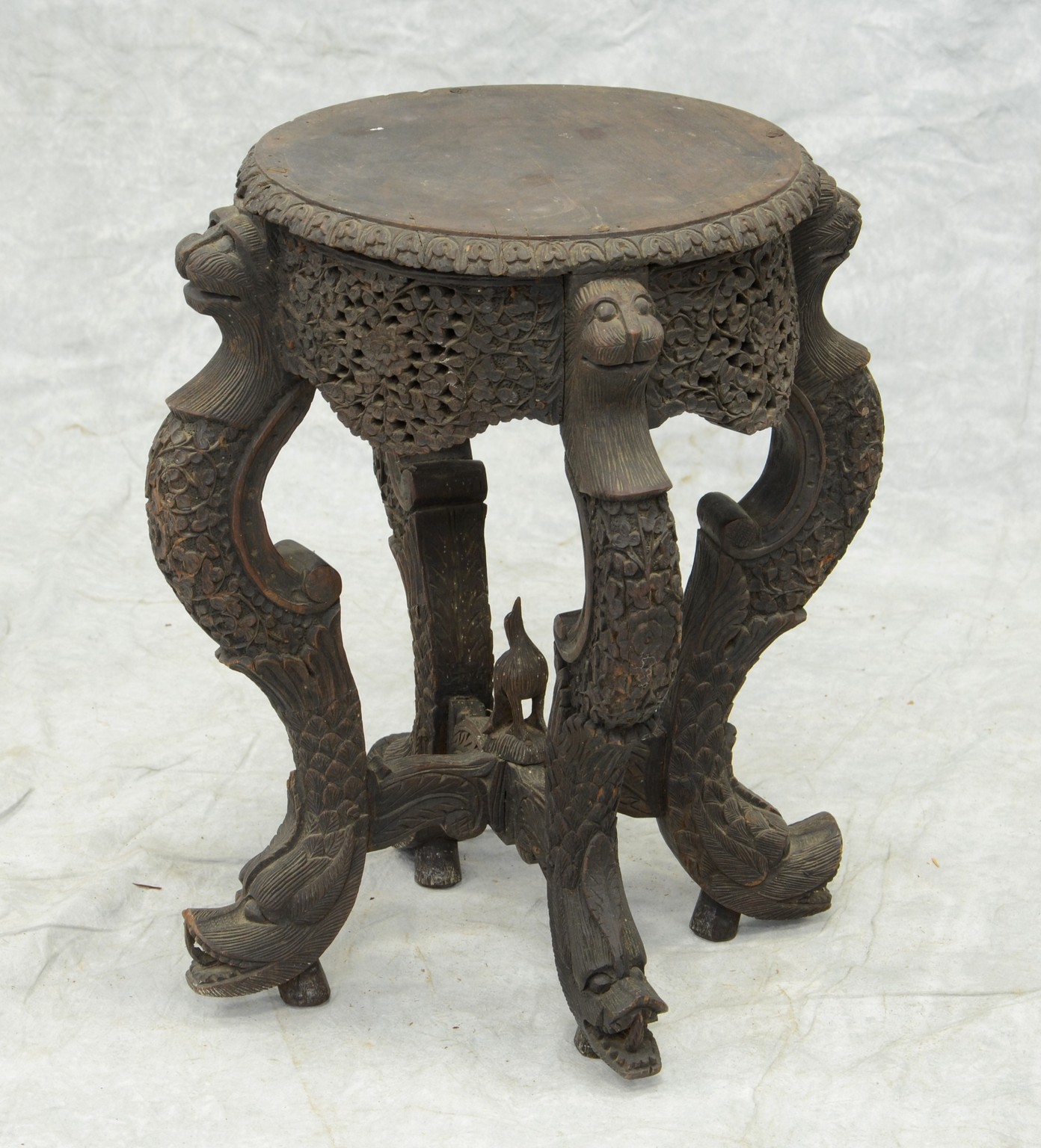 Appraisal: Carved Burmese taboret stand animal heads at top and bottom