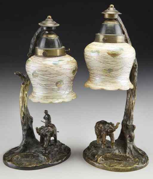 Appraisal: Pr Quezal bronze and glass lamps figural tree trunk standards