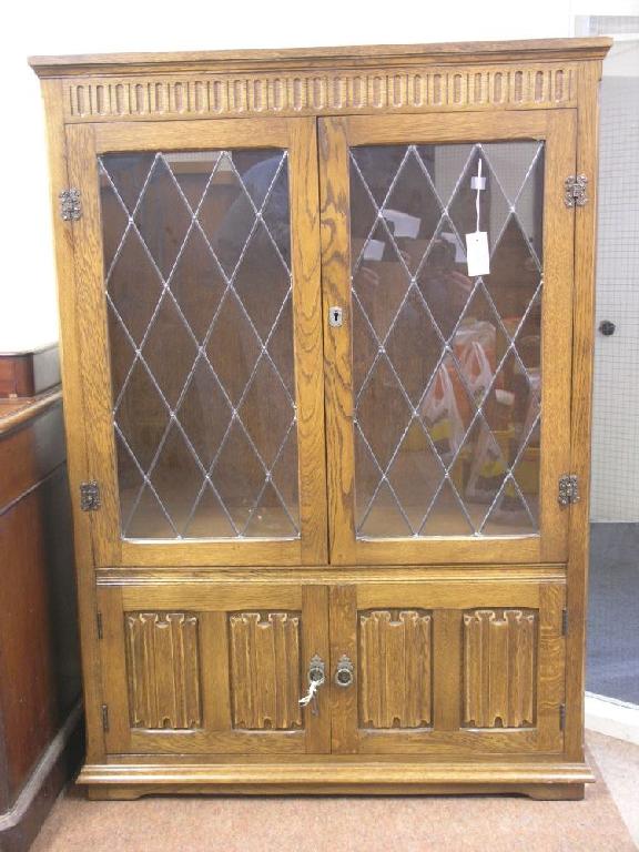 Appraisal: A reproduction medium oak bookcase pair of leaded glazed doors