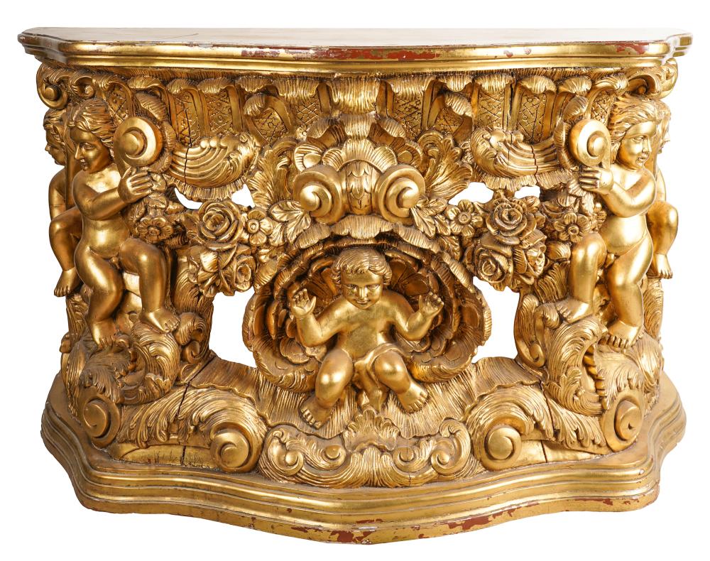 Appraisal: CARVED GILTWOOD SIDE TABLEof serpentine outline carved with cherubs flowers