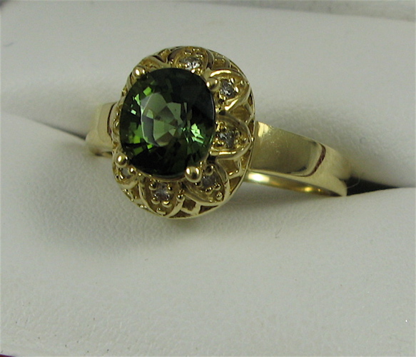 Appraisal: PERIDOT DIAMOND AND K GOLD RING centering an oval-cut green-yellow