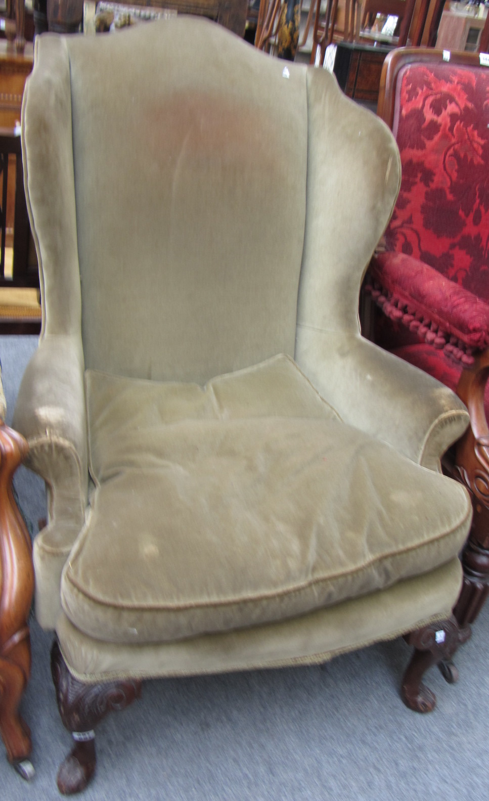 Appraisal: An early th century style wingback armchair on carved squat