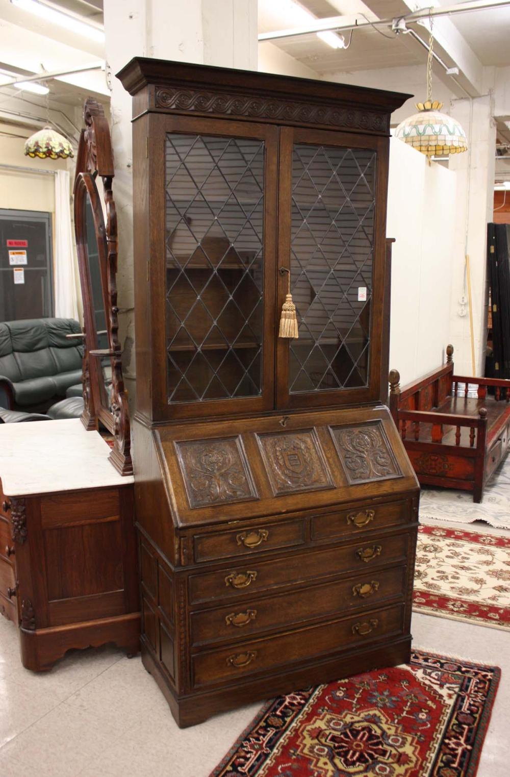 Appraisal: VINTAGE CARVED FEUDAL OAK SECRETARY BOOKCASE Royal Charter Collection by