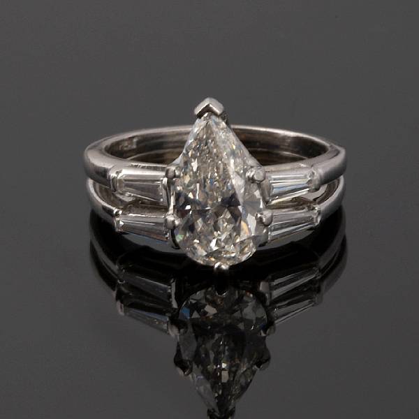 Appraisal: A diamond ring centering a pear-shaped diamond weighing an estimated