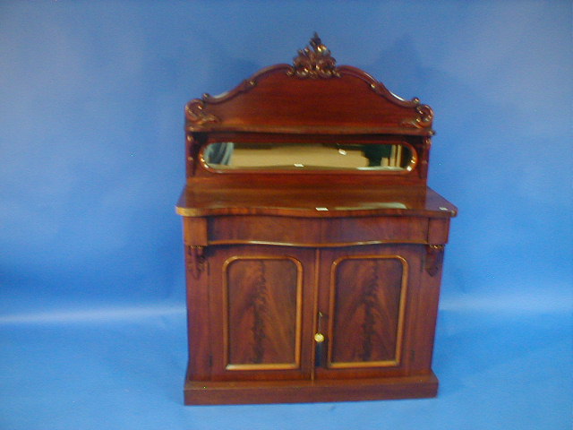 Appraisal: A Victorian mahogany serpentine chiffonier with mirror and shelf back