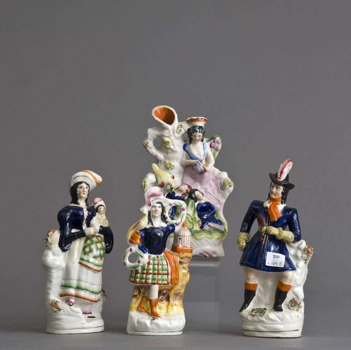 Appraisal: FOUR STAFFORDSHIRE FIGURAL GROUPS WITH COBALT BLUE DECORATION Height of