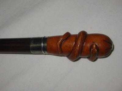 Appraisal: A WALKING STICK the rosewood grip of tapering form carved