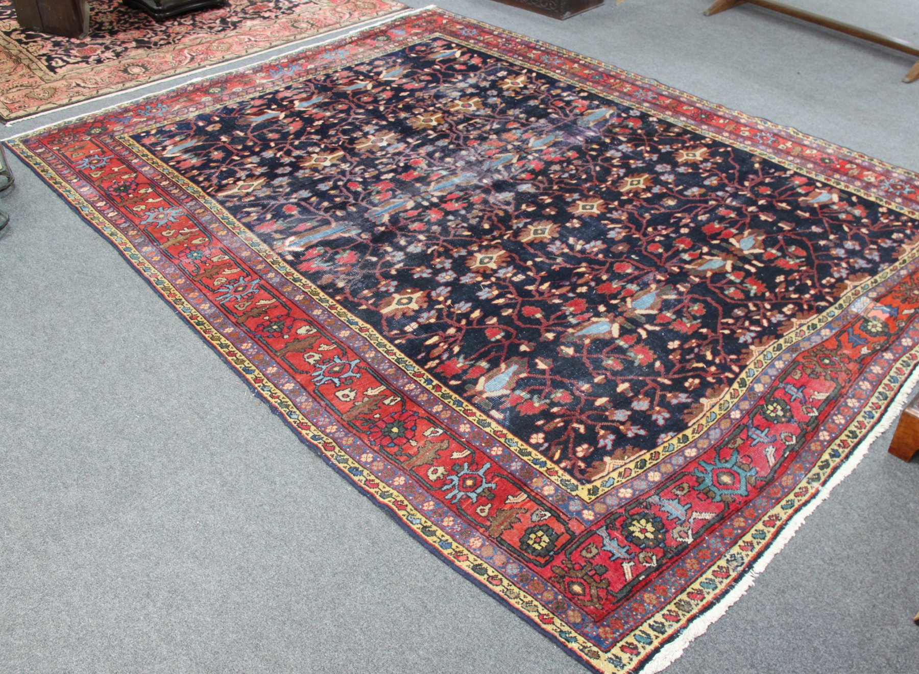 Appraisal: A Kurdish carpet flowers on an indigo ground within a