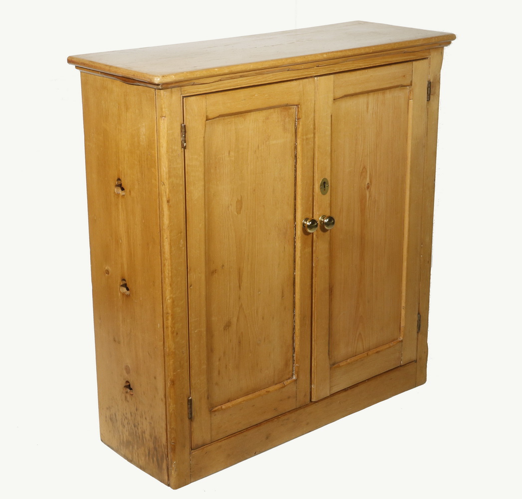 Appraisal: SCRUBBED PINE TWO-DOOR CUPBOARD Scrubbed pine two-door cupboard with brass