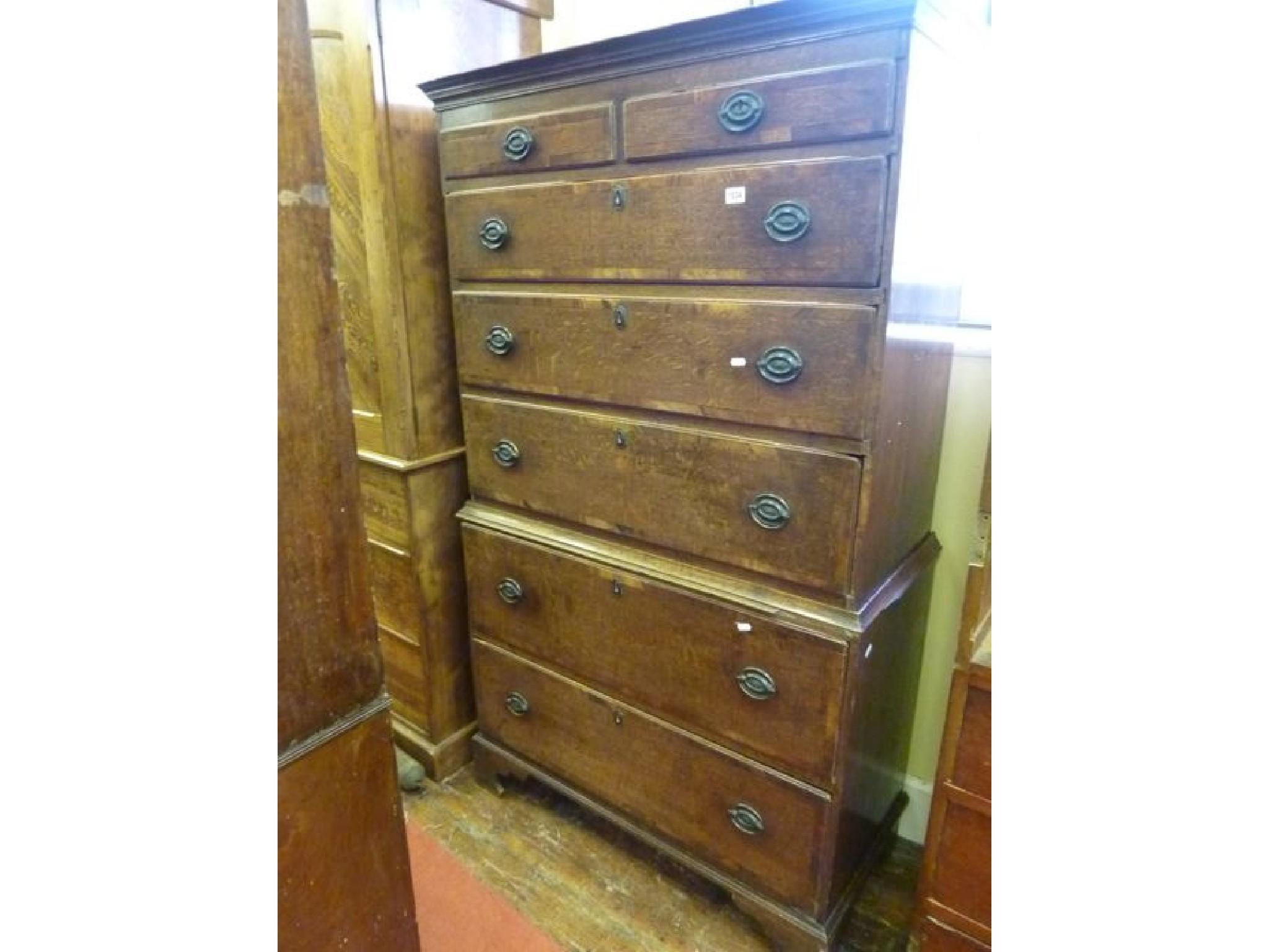 Appraisal: A Georgian oak chest on chest fitted with an arrangement