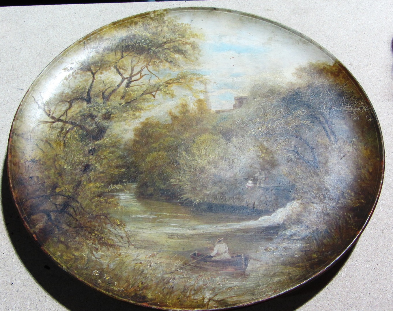 Appraisal: A circular terracotta plate with a painted river scene