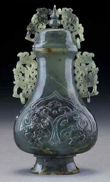 Appraisal: Chinese carved jade vasedepicting the face of the beast with