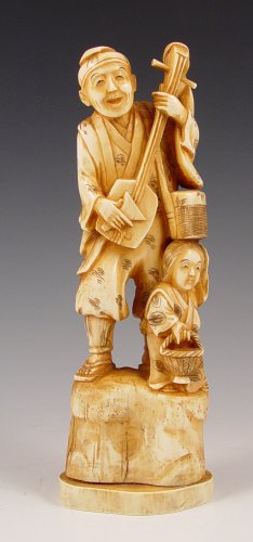 Appraisal: CARVED IVORY FIGURE MAN WITH INSTRUMENT GROUP Figure on man